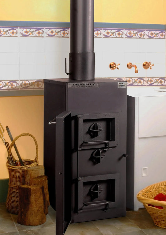 Open WISELIVING Dynamic 2500 hydronic boiler stove showing its control panel and heating components in a well-lit setting.