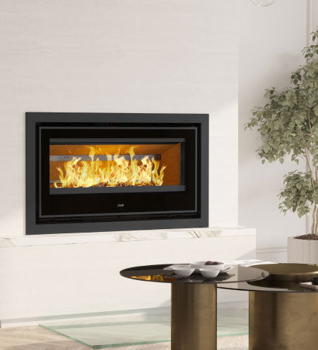 ADF Clare 100S Insert Fireplace showing the black metal frame and glass front for efficient home heating and cozy ambiance.