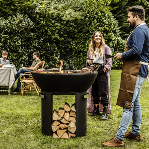Castworks Hergóm Zenith High Base Fire Pit complete outdoor fireplace set with metal fire bowl and fire tools.