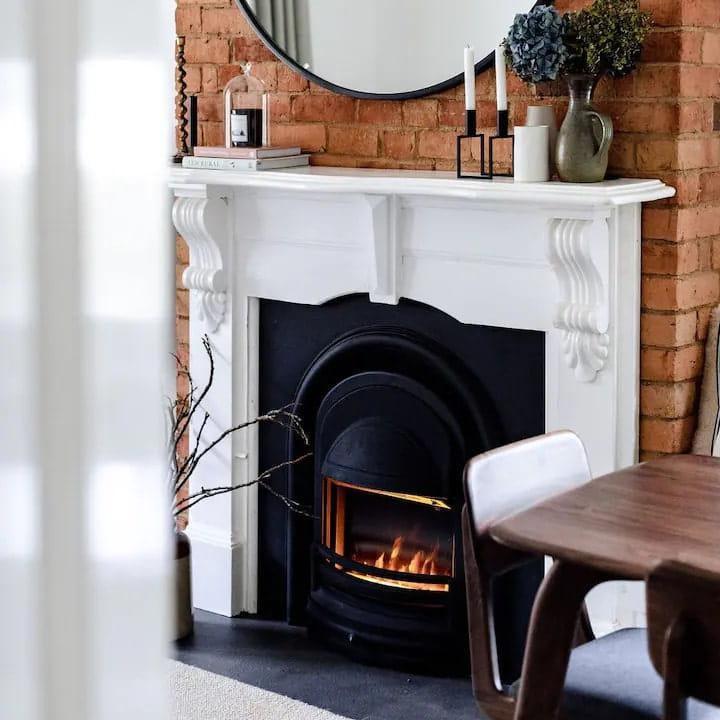 Integra Anson electric fireplace installed with a traditional white fireplace mantel