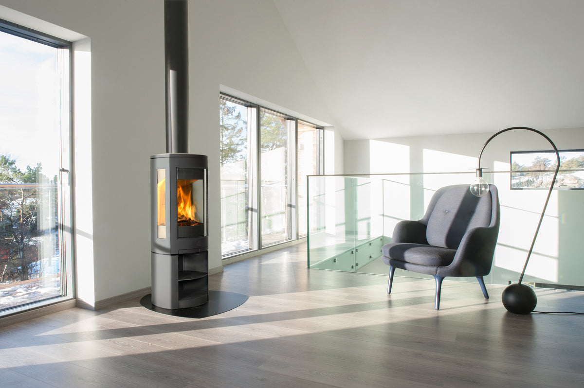 Jøtul F 370 V2 Advance three-sided wood heater installed in a bright contemporary home
