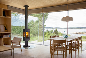 Jøtul F 370 V2 Advance freestanding wood heater beside a modern dining area