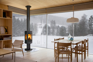 Jøtul F 370 V2 Advance wood heater warming a dining area in winter