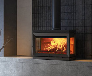 Jøtul F 620 wood heater installed in a modern home with panoramic three-sided fire view