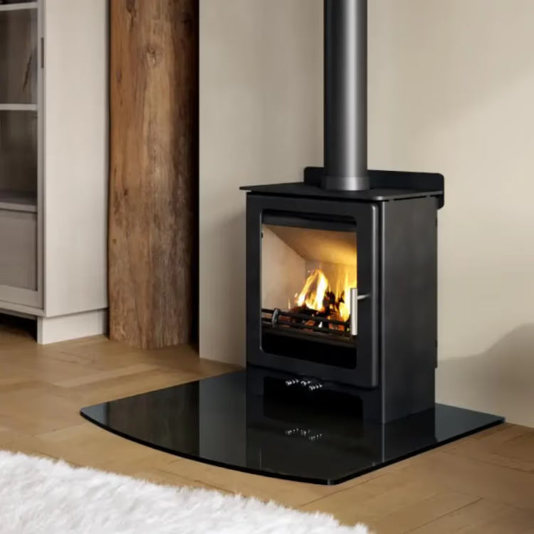 Loxton 5 Standard freestanding wood heater installed on a black hearth