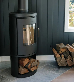 Morsø 6143 freestanding wood heater installed with firewood storage