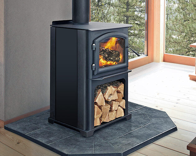 Quadra-Fire Discovery 31LE wood heater installed in a corner with firewood storage