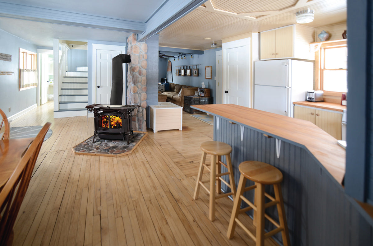 Vermont Castings Encore black wood heater installed in an open-plan home