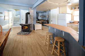 Vermont Castings Encore black wood heater installed in an open-plan home