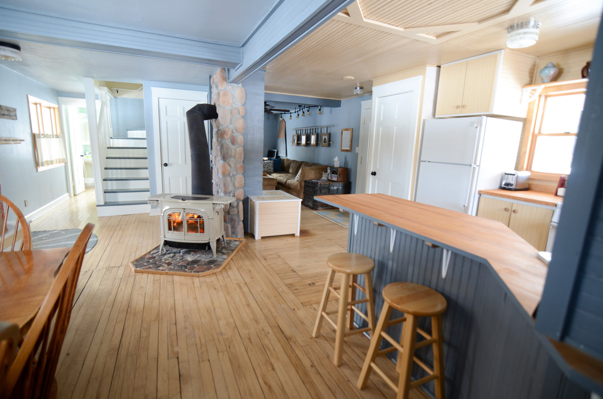 Vermont Castings Encore freestanding wood heater in a modern open-plan interior