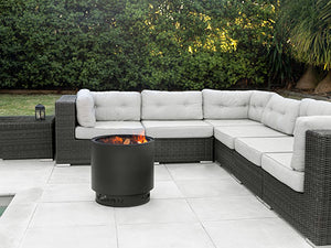 VisionLINE MK2 black outdoor fire pit in a backyard entertaining area