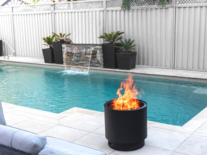 VisionLINE MK2 Outdoor Fire Pit burning beside a swimming pool