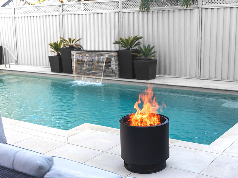 VisionLINE MK2 Outdoor Fire Pit burning beside a swimming pool