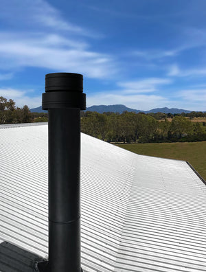 VisionLINE pellet heater flue with black roof termination installed through a metal roof