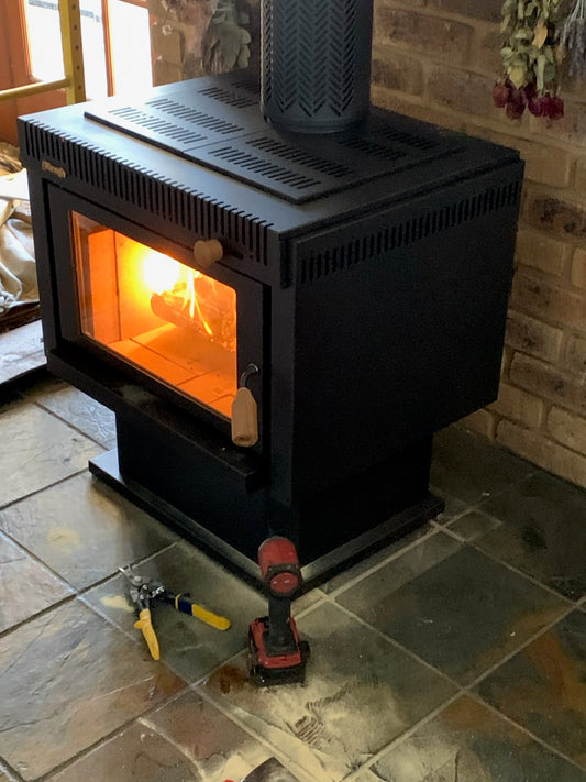 Warmglo Ranger 2500 wood fireplace with a modern design, featuring a large glass front and warm glowing fire inside.