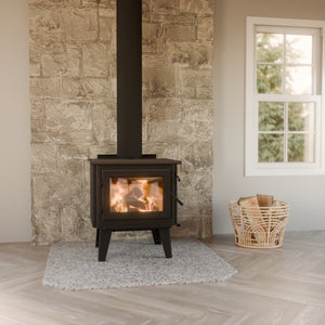 WoodPro WP 200 wood fireplace installed in a bright living room with stone wall