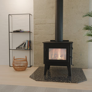 WoodPro WP 300 freestanding wood heater installed against a stone wall in a modern living room