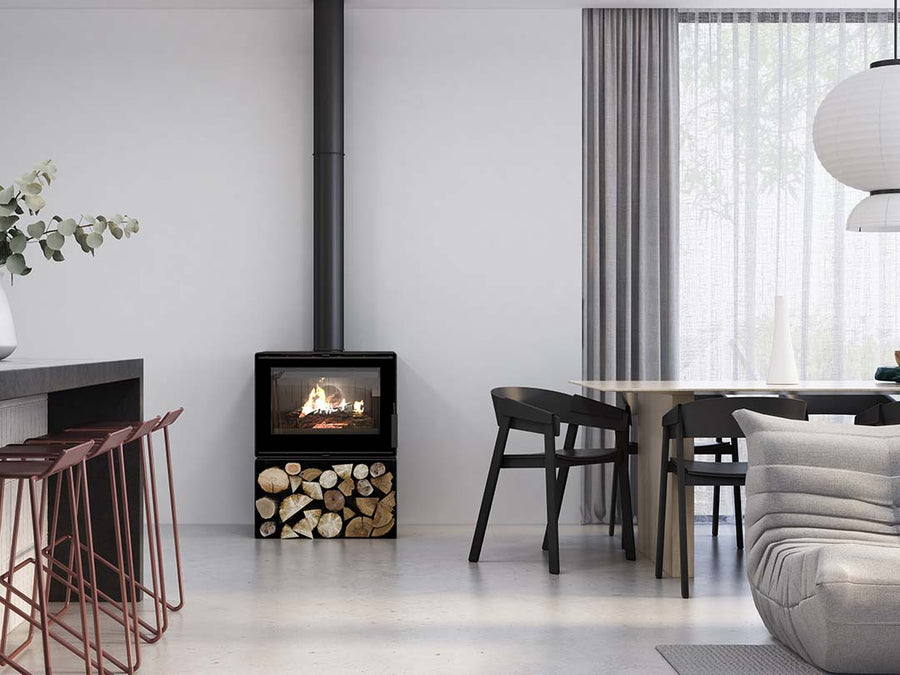 VisionLINE Phoenix Wood Stove in a cozy living room, showcasing its glass door and sleek black finish as a wood fireplace.